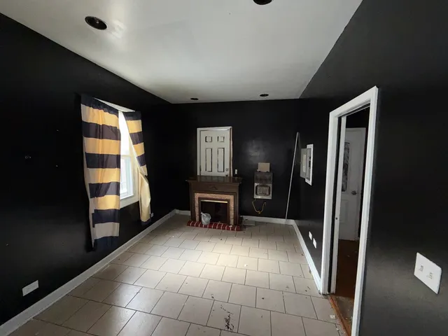 a view of a hallway with furniture and a window