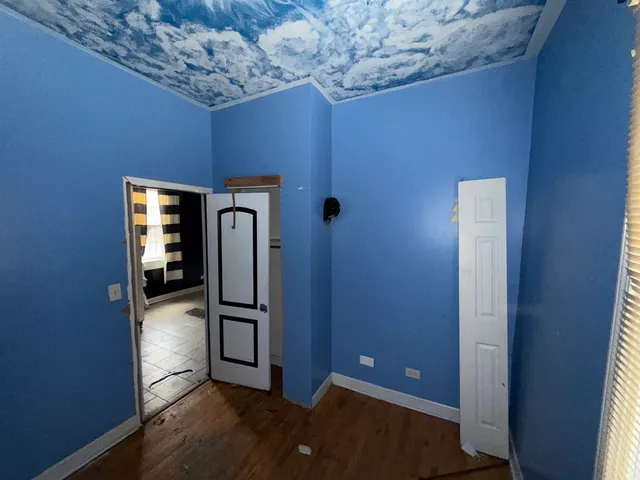 a view of a livingroom with wooden floor and a window