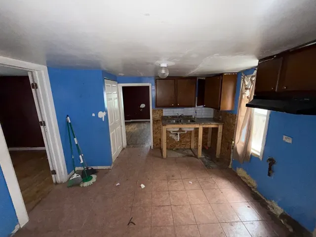 a kitchen with refrigerator and cabinets