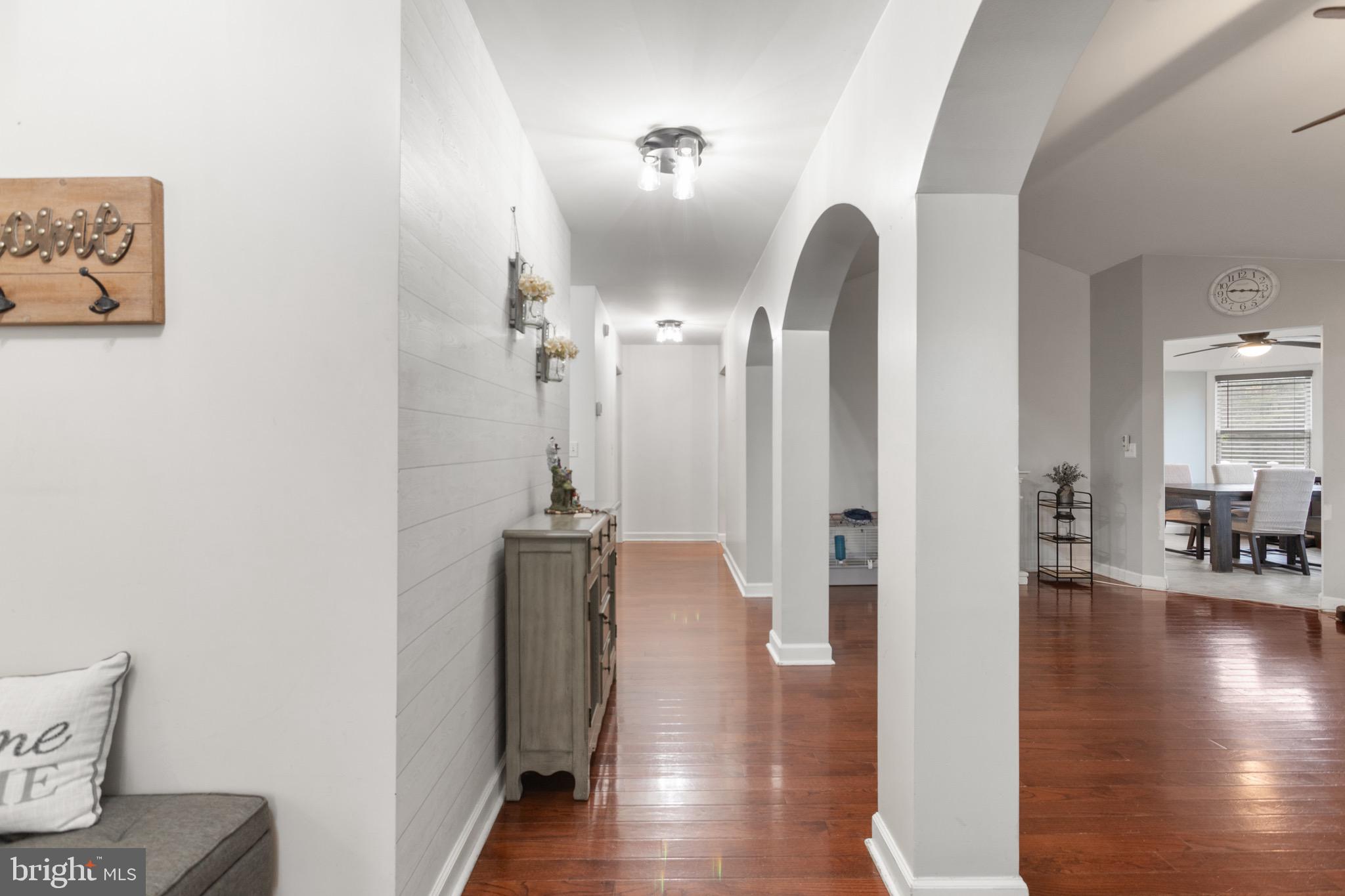 26179 Manor Way Georgetown, DE 19947 - Photo 11 of 87 a view of a hallway with wooden floor and furniture