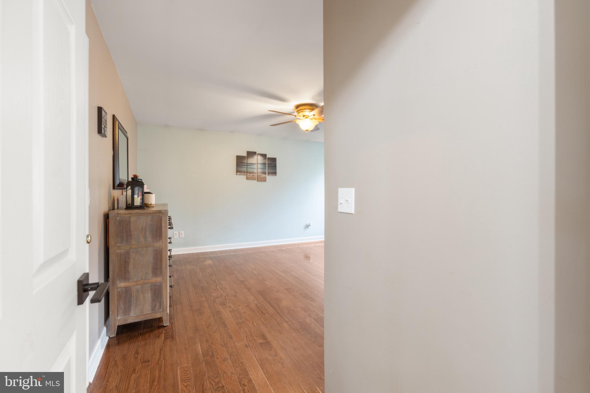 26179 Manor Way Georgetown, DE 19947 - Photo 23 of 87 a view of a hallway with wooden floor and a cabinet