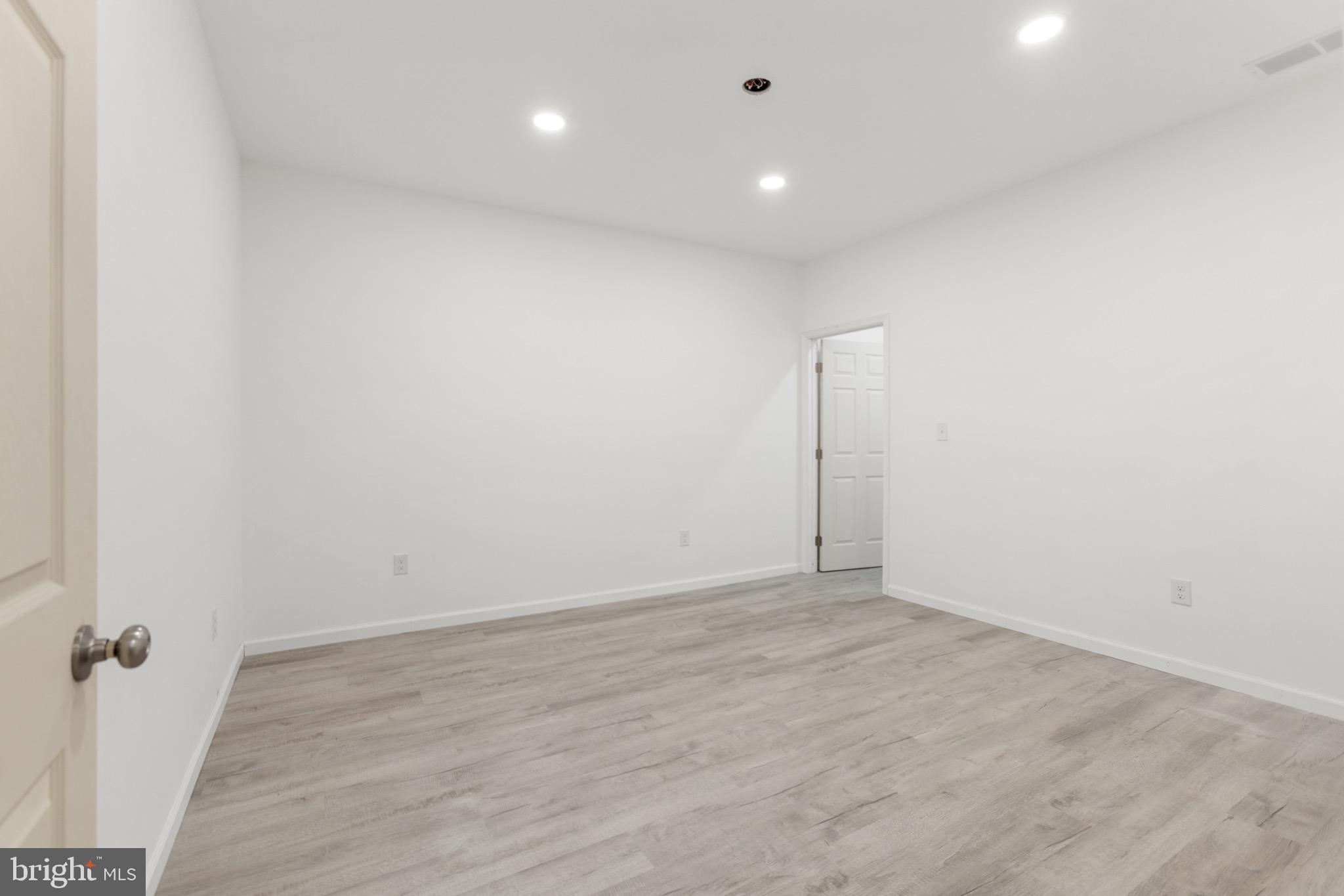 26179 Manor Way Georgetown, DE 19947 - Photo 33 of 87 an empty room with wooden floor and bathroom