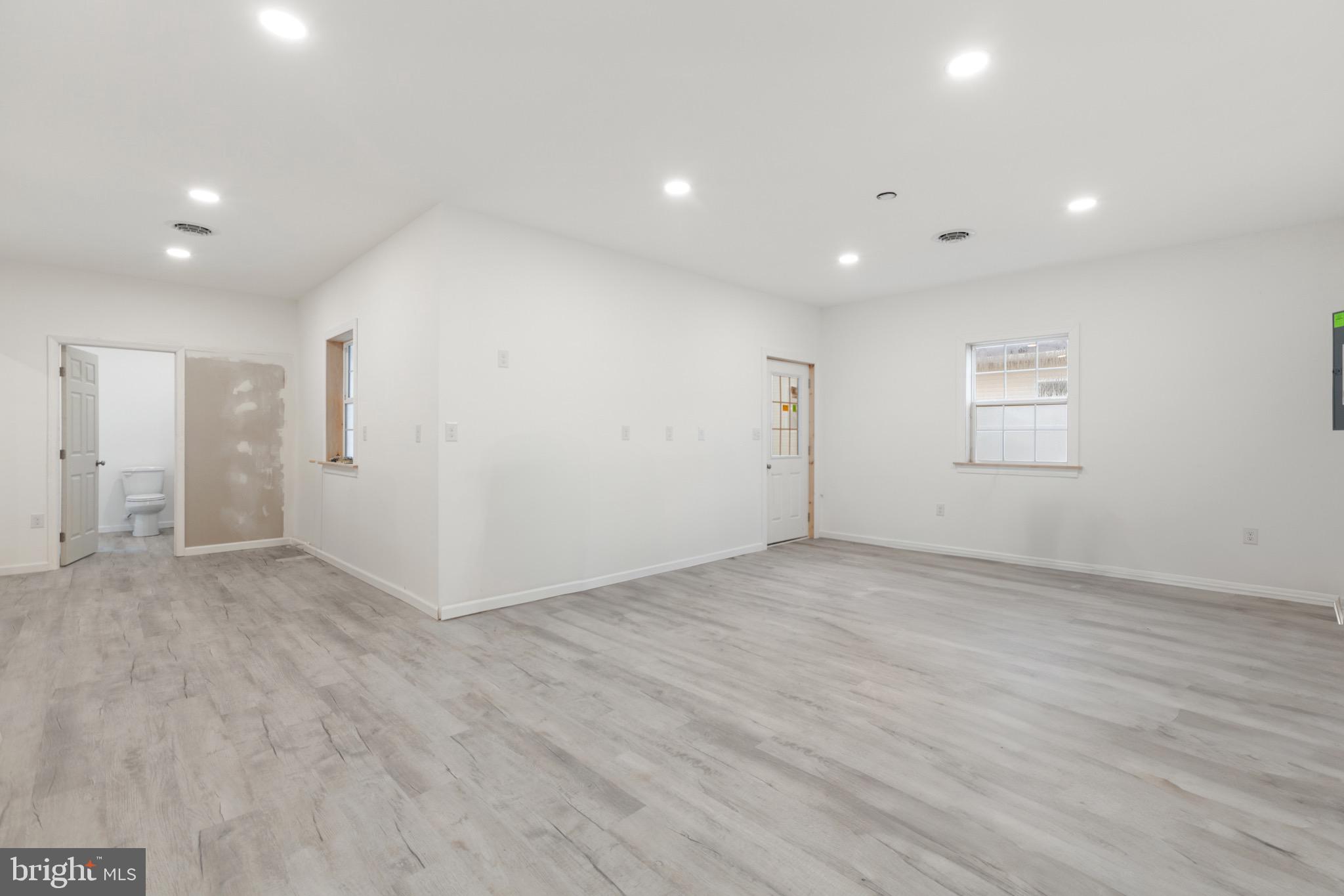 26179 Manor Way Georgetown, DE 19947 - Photo 38 of 87 an empty room with wooden floor and windows