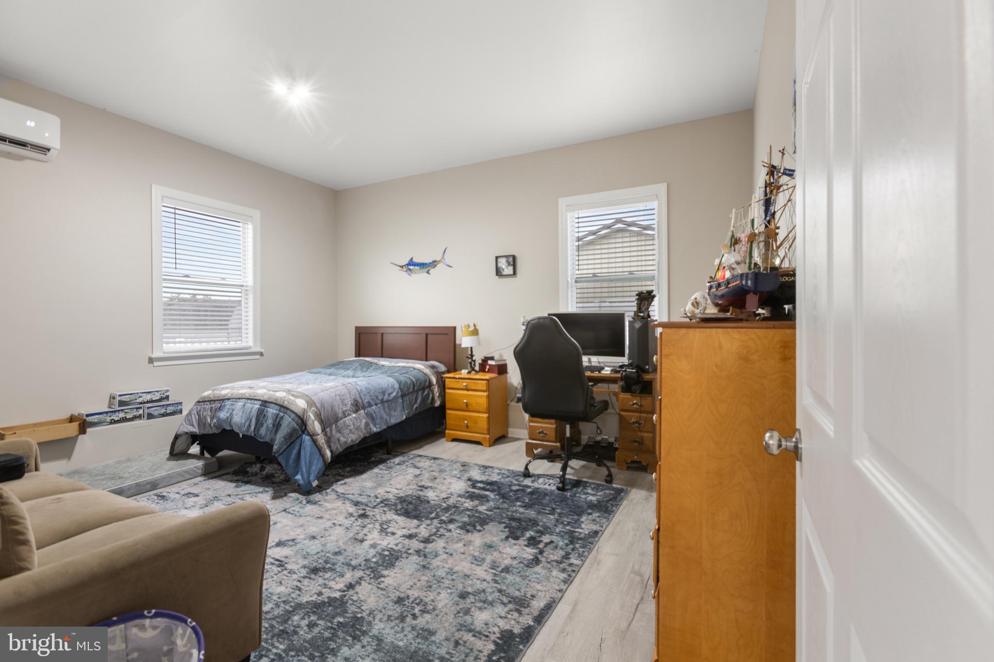 26179 Manor Way Georgetown, DE 19947 - Photo 5 of 87 a bedroom with a bed and wooden floor
