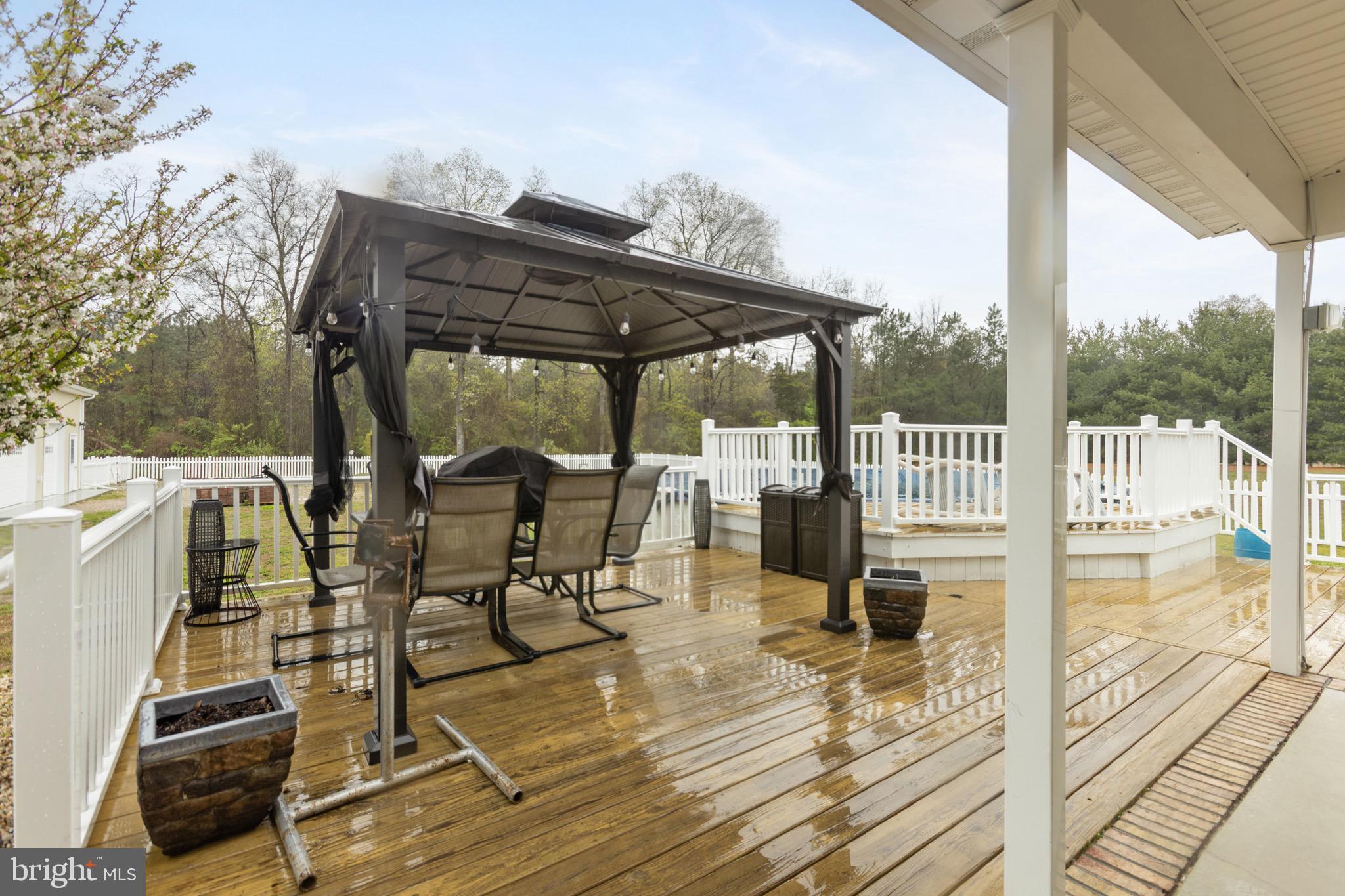 26179 Manor Way Georgetown, DE 19947 - Photo 57 of 87 a view of balcony with wooden floor and outdoor seating
