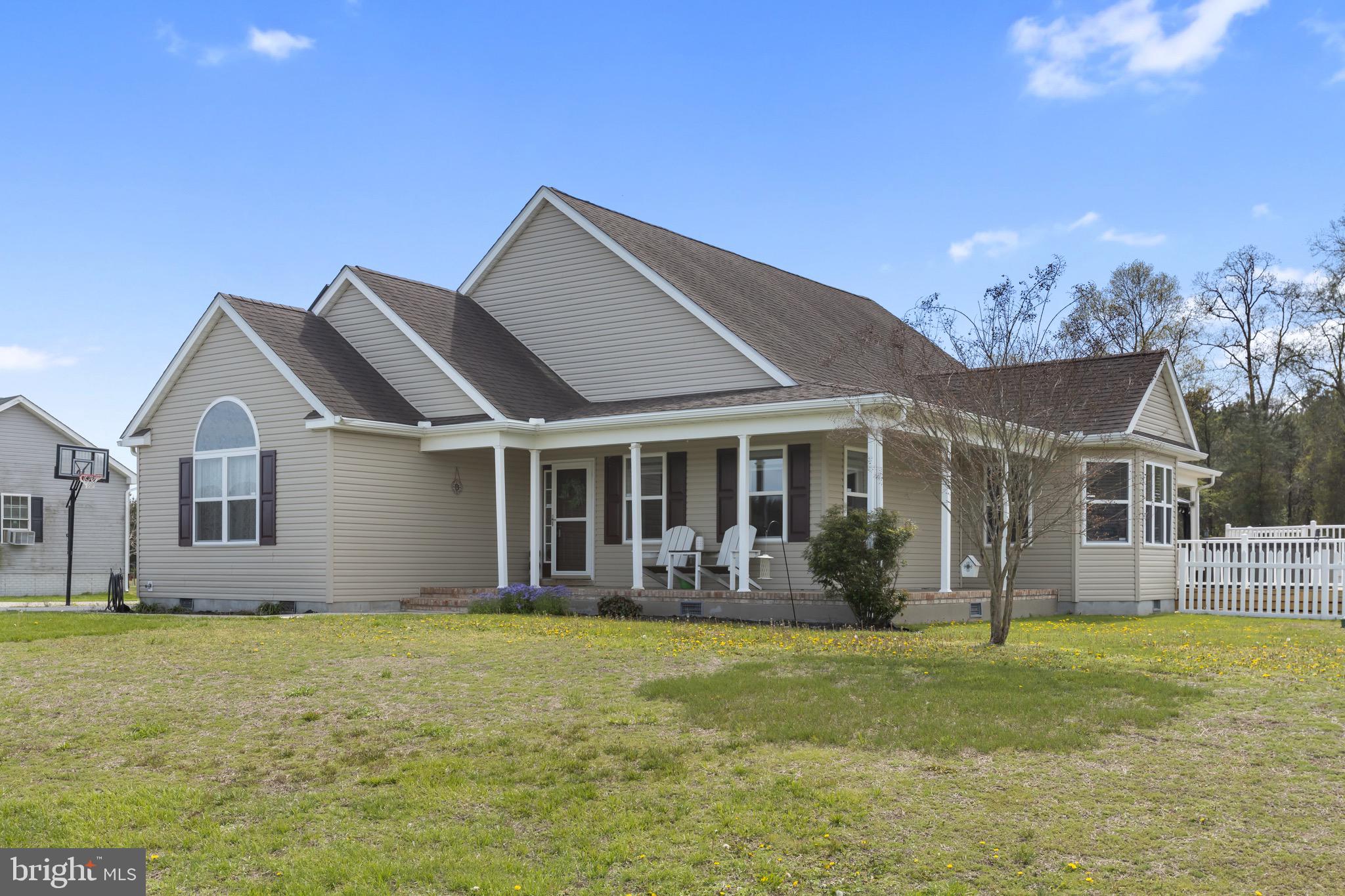 26179 Manor Way Georgetown, DE 19947 - Photo 78 of 87 a front view of house with yard outdoor seating and barbeque oven