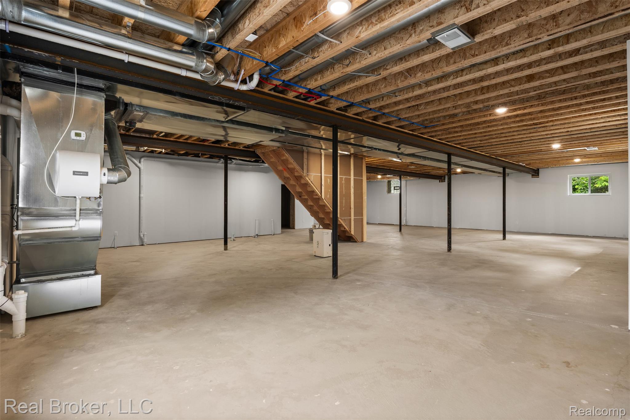 12114 22 Mile Road Utica, MI 48315 - Photo 56 of 70 Expansive unfinished basement featuring concrete flooring, exposed wood joists, a visible furnace, and a window for natural light
