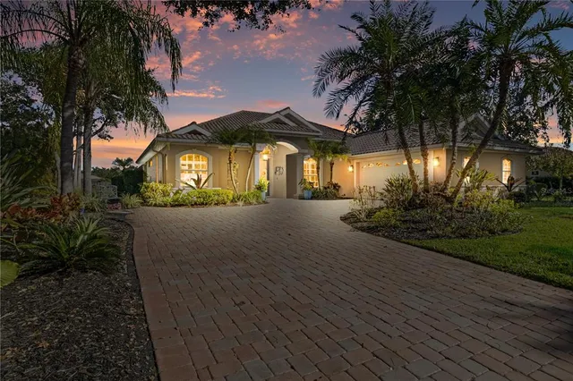 a front view of a house with a yard and green space