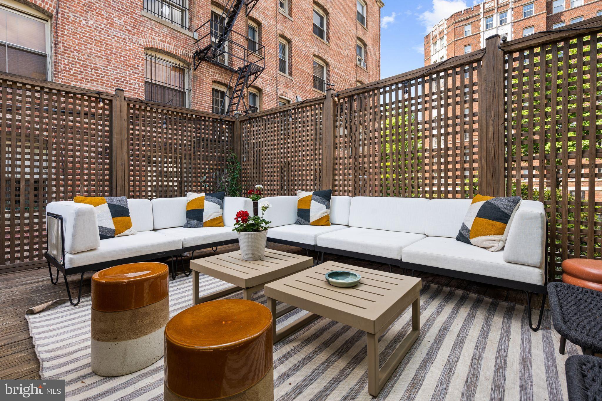 2026 15th Street Northwest Washington, DC 20009 - Photo 40 of 47 a outdoor sitting area with a couch and wooden floor