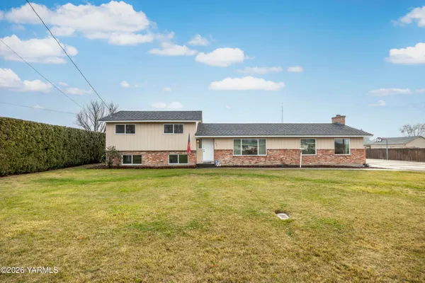 a front view of a house with a garden and deck