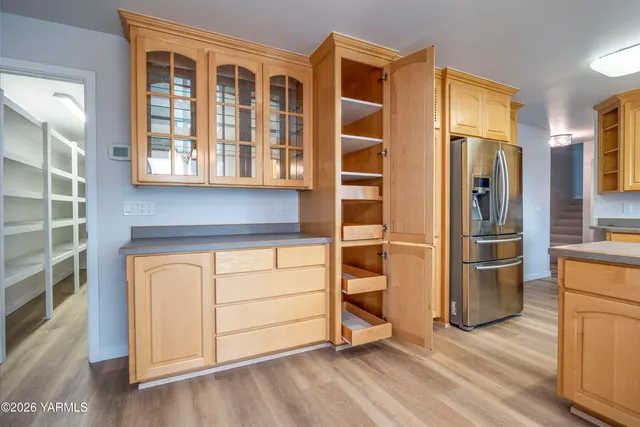 a kitchen with stainless steel appliances wooden floor and brick cabinets