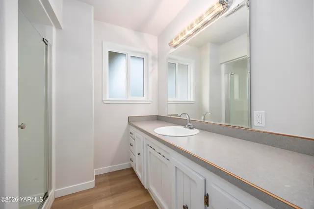 a spacious bathroom with a double vanity sink and a mirror