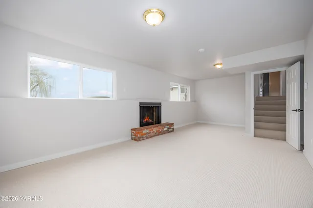 a view of a livingroom with furniture and a window