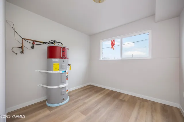 a view of a small space with wooden floor and a window