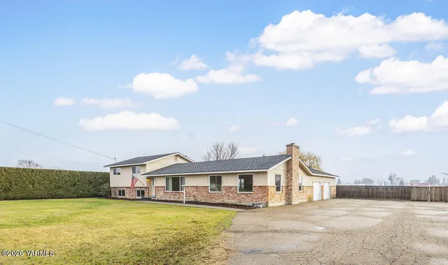 a view of a house with a swimming pool with a yard