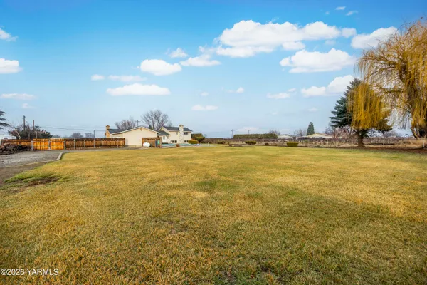 a view of a backyard with swimming pool