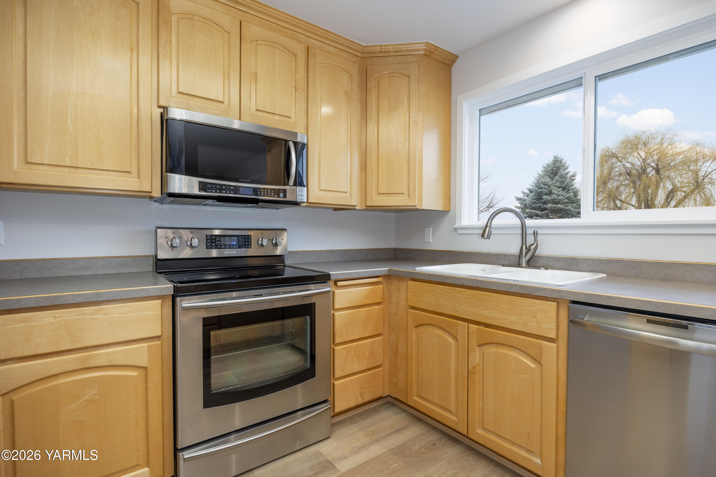 790 East Bonnieview Road Grandview, WA 98930 - Photo 10 of 49 a kitchen with cabinets stainless steel appliances a sink and a stove