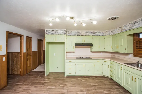 a kitchen with a sink cabinets and window