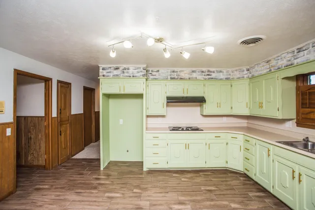 a kitchen with a sink cabinets and window