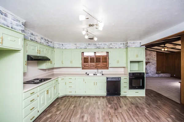 a view of a room with wooden floor staircase and a bathroom
