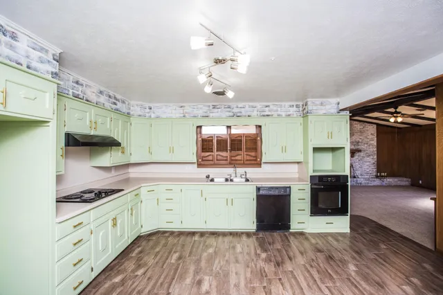 a view of a room with wooden floor staircase and a bathroom