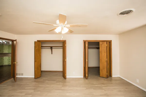 a bathroom with a granite countertop shower and a toilet