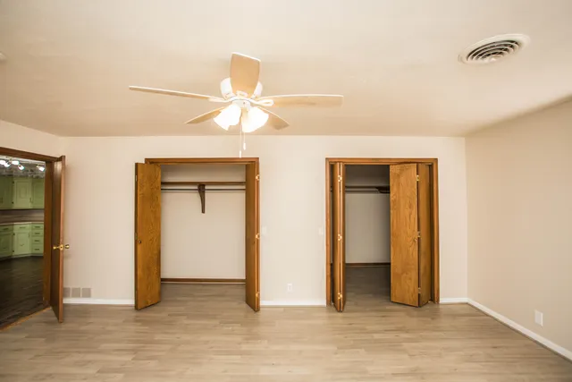 a bathroom with a granite countertop shower and a toilet