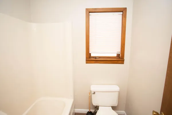 a spacious bathroom with a granite countertop sink toilet and shower
