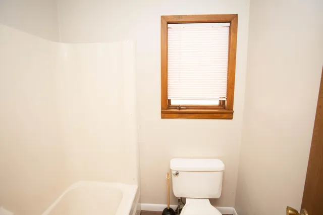 a spacious bathroom with a granite countertop sink toilet and shower