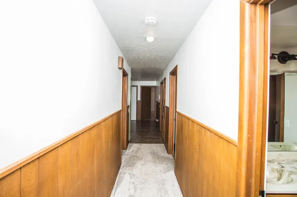a view of a livingroom with wooden floor and a window