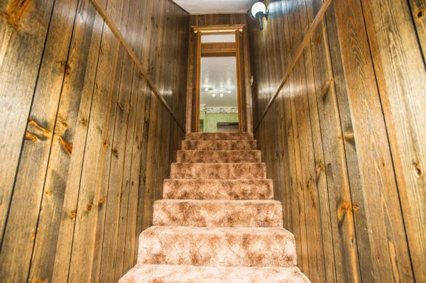a view of staircase with railing and white walls