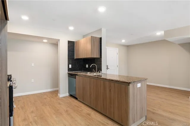 a kitchen with stainless steel appliances granite countertop a sink and cabinets