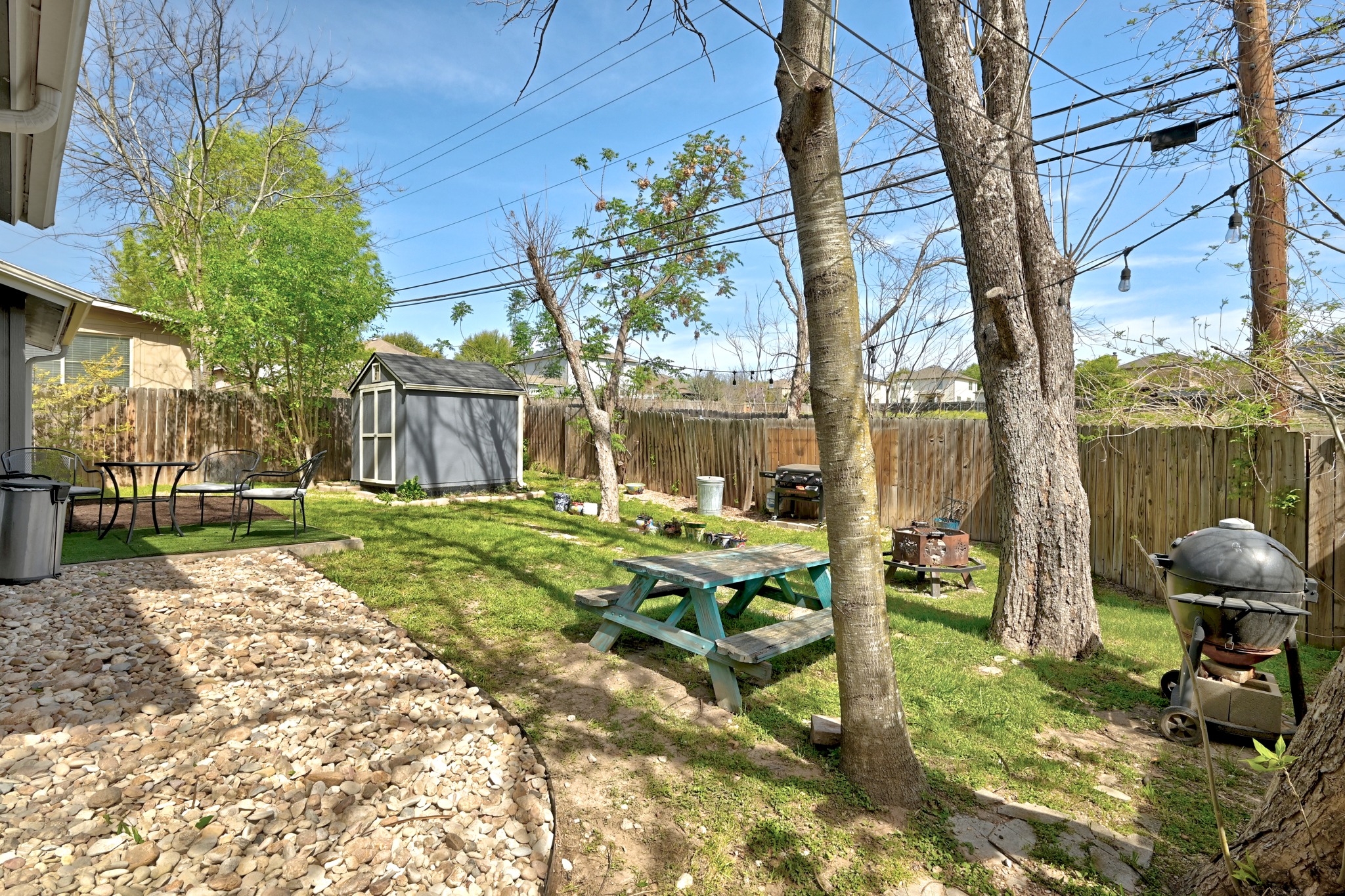 5610 Fence Row Austin, TX 78744 - Photo 21 of 26 Fenced backyard with an upgraded storage shed and a patio area