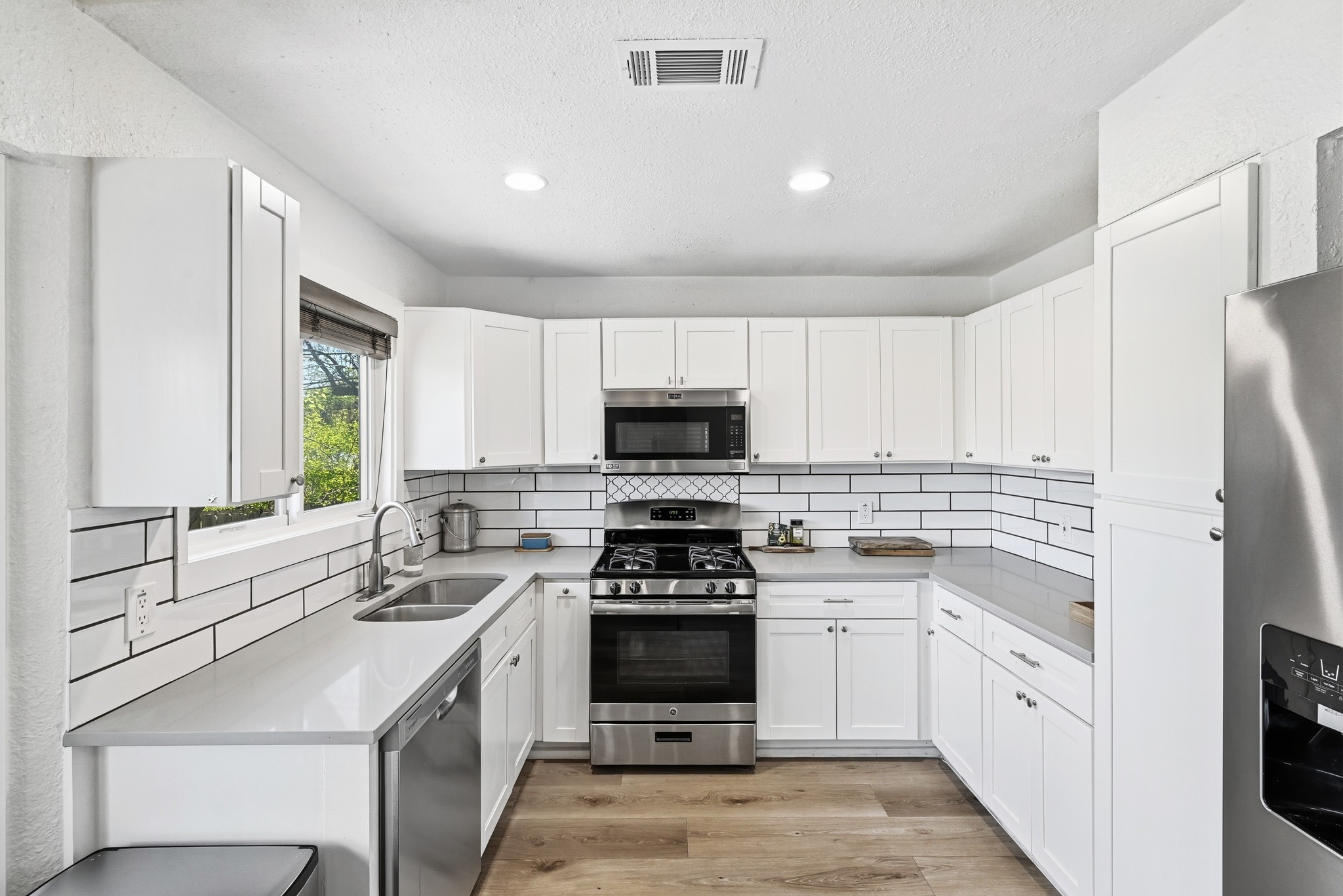 5610 Fence Row Austin, TX 78744 - Photo 5 of 26 Modern kitchen with stone countertops and a new dishwasher!