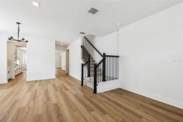 a view of entryway and hall with wooden floor
