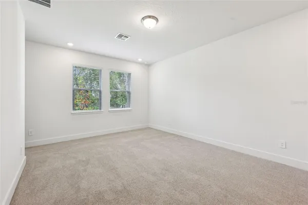 a spacious bathroom with a toilet sink and mirror
