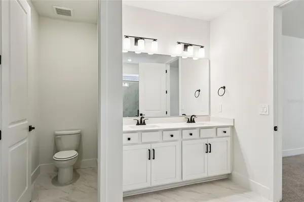 a spacious bathroom with shower sink and mirror
