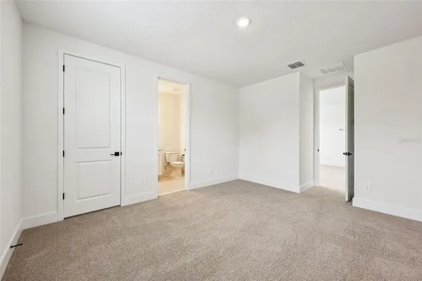 a bathroom with a sink a toilet and a large mirror