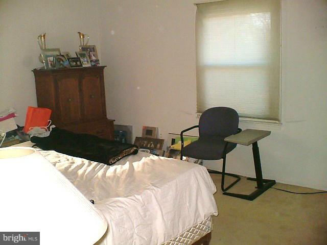 19529 Olney Mill Road Olney, MD 20832 - Photo 4 of 10 a bedroom with a bed and a chair
