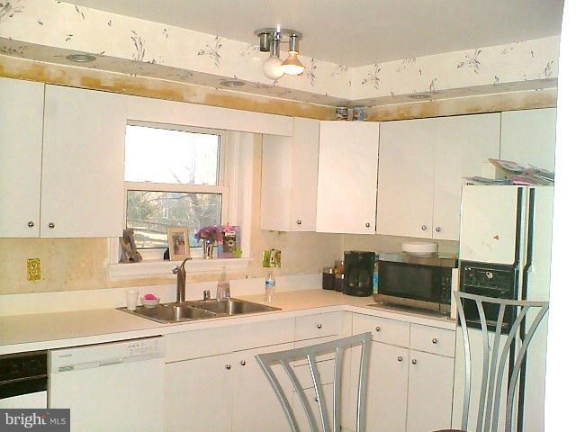 19529 Olney Mill Road Olney, MD 20832 - Photo 10 of 10 a kitchen with a sink a stove a refrigerator a window and cabinets
