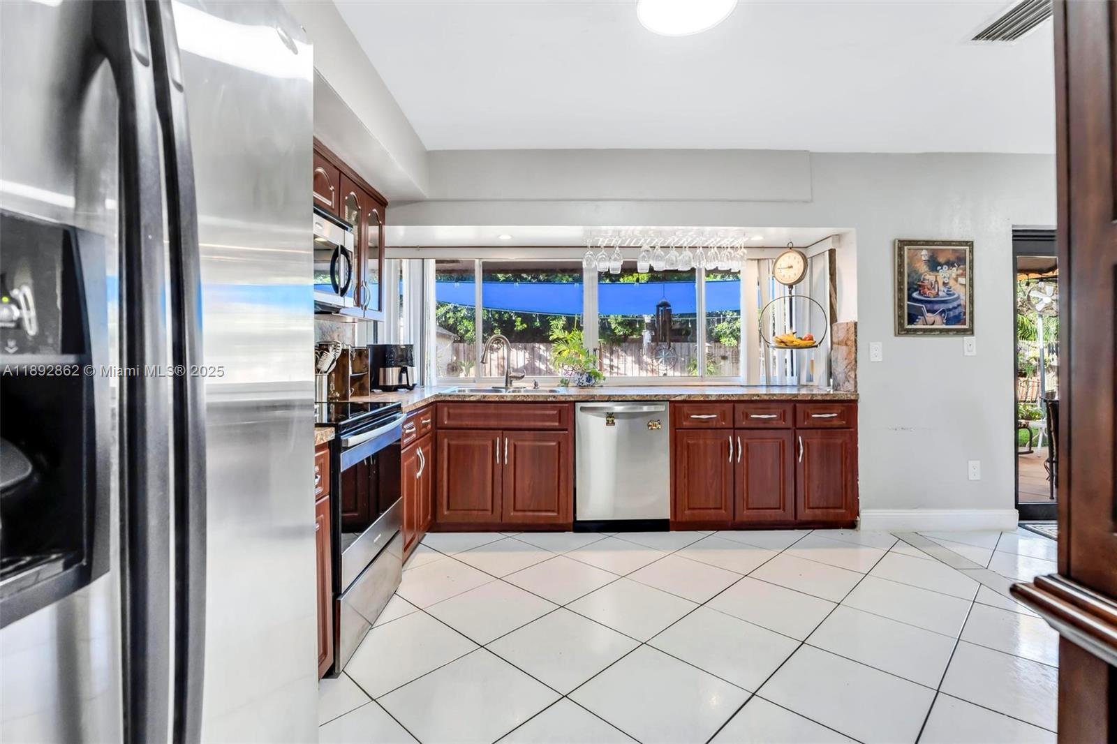 8111 Southwest 205th Street Cutler Bay, FL 33189 - Photo 11 of 51 a kitchen with stainless steel appliances a sink and a refrigerator