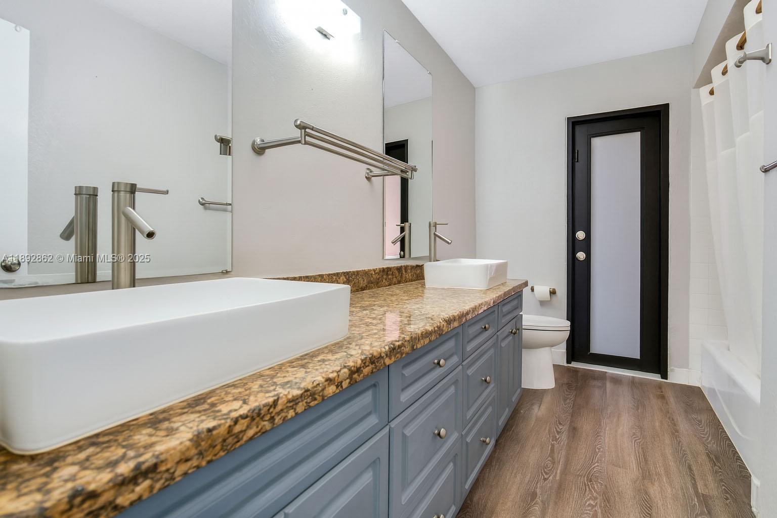 8111 Southwest 205th Street Cutler Bay, FL 33189 - Photo 12 of 51 a bathroom with a granite countertop double vanity sink and mirror