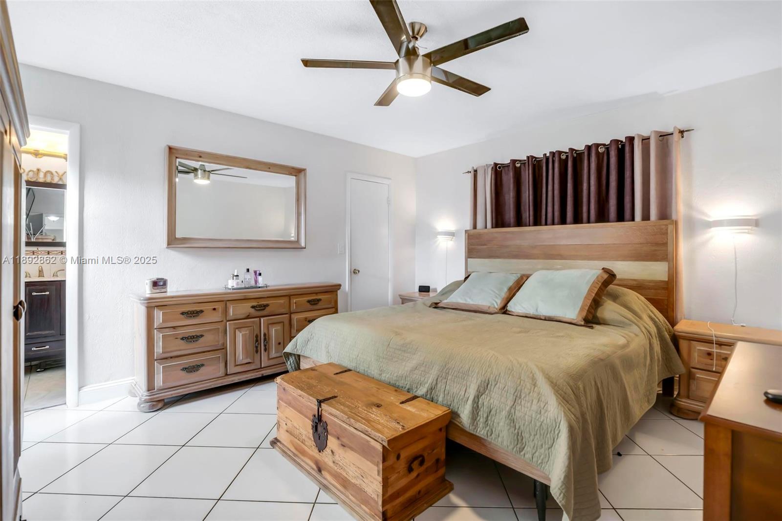 8111 Southwest 205th Street Cutler Bay, FL 33189 - Photo 15 of 51 a bedroom with a bed and dresser