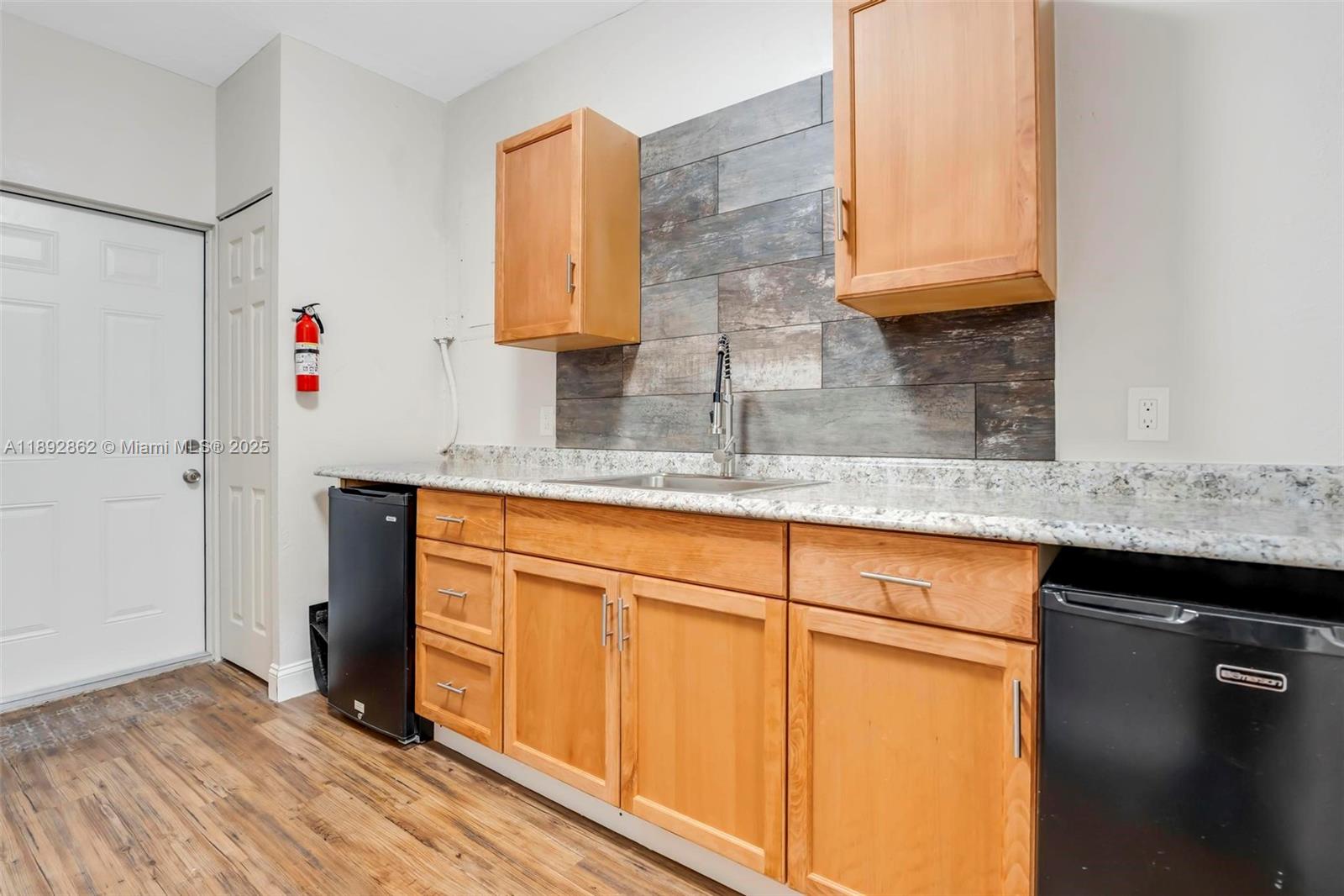 8111 Southwest 205th Street Cutler Bay, FL 33189 - Photo 18 of 51 a kitchen with stainless steel appliances granite countertop a sink and a cabinets