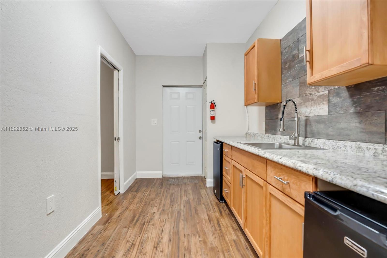 8111 Southwest 205th Street Cutler Bay, FL 33189 - Photo 19 of 51 a kitchen with a sink and wooden floor