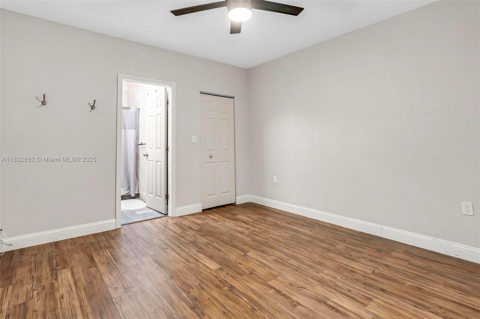 8111 Southwest 205th Street Cutler Bay, FL 33189 - Photo 20 of 51 a view of an empty room with wooden floor