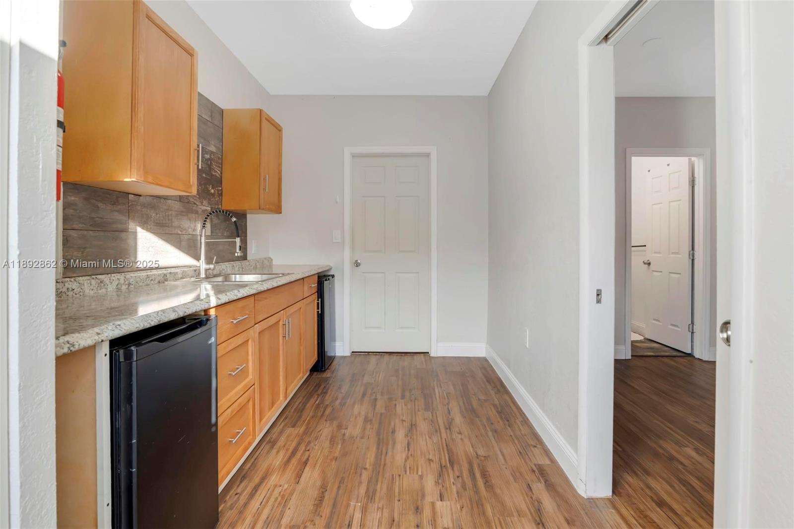 8111 Southwest 205th Street Cutler Bay, FL 33189 - Photo 23 of 51 a view of a kitchen from the hallway