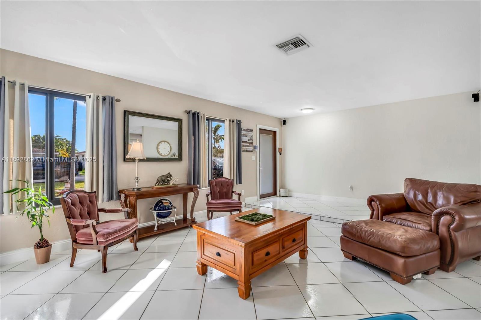 8111 Southwest 205th Street Cutler Bay, FL 33189 - Photo 4 of 51 a living room with furniture and a large window