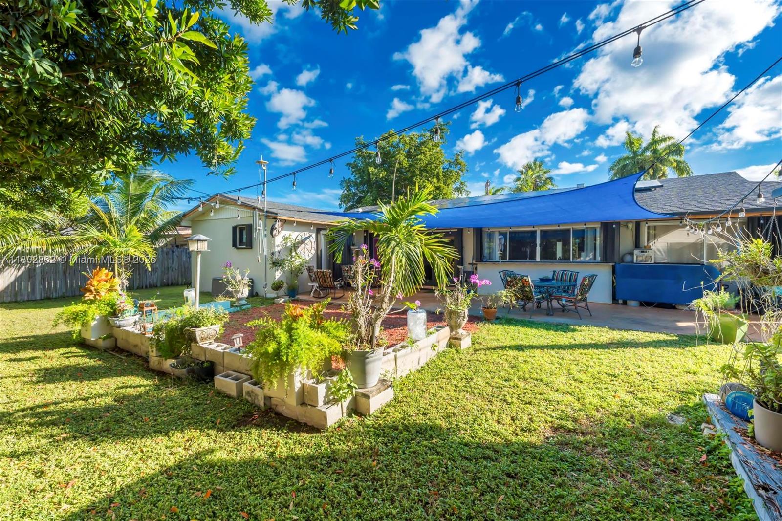 8111 Southwest 205th Street Cutler Bay, FL 33189 - Photo 46 of 51 a view of a house with swimming pool lawn chairs and a yard