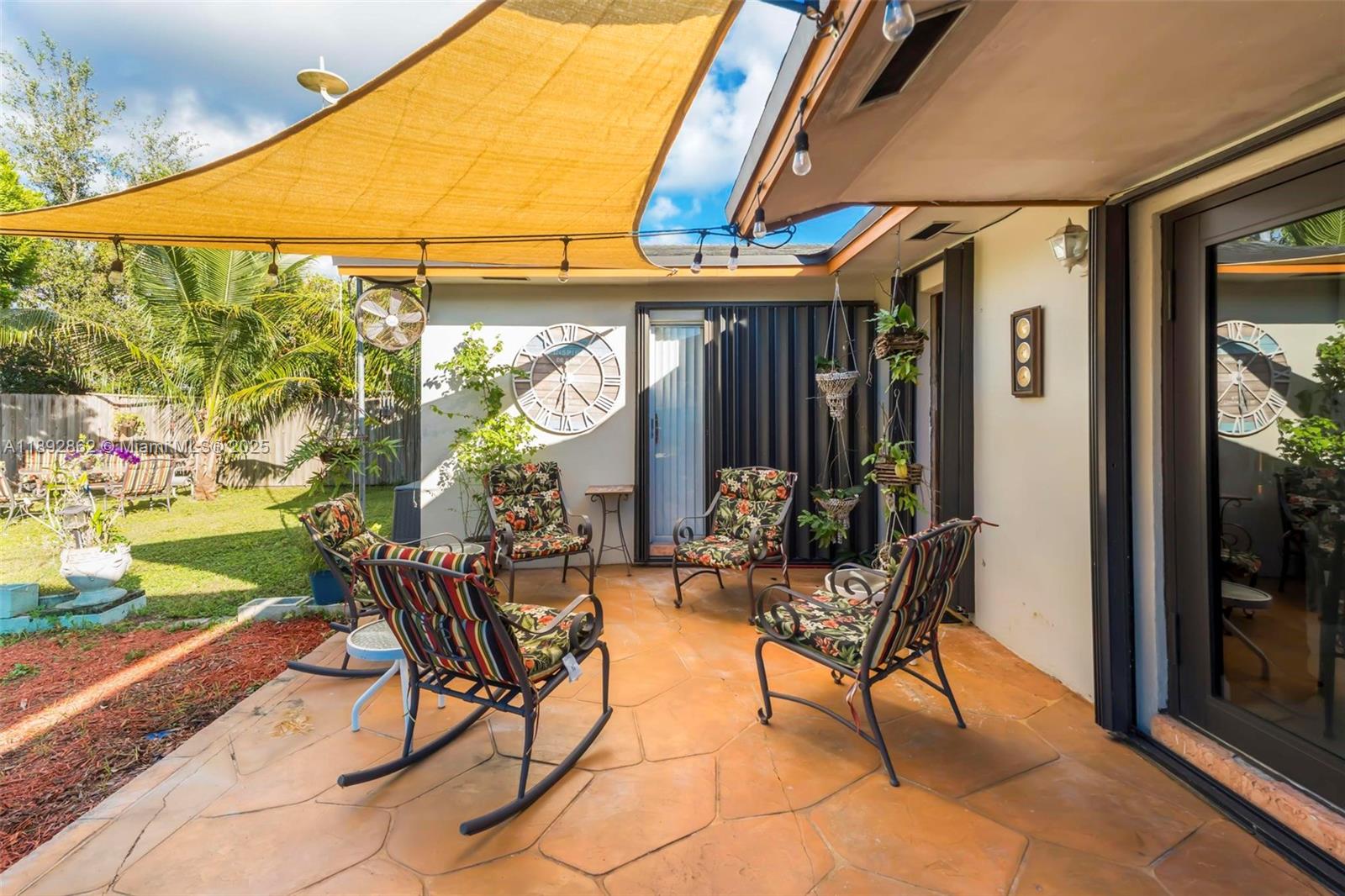 8111 Southwest 205th Street Cutler Bay, FL 33189 - Photo 50 of 51 a building outdoor space with patio furniture and potted plants